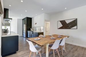 a kitchen and dining room with a wooden table and chairs at DL882 - Desert Falls Poolside Escape - Alice Lodging in Palm Desert