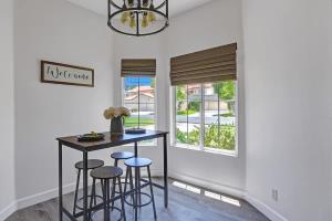 a dining room with a table and stools at DL882 - Desert Falls Poolside Escape - Alice Lodging in Palm Desert