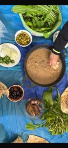 a table topped with a table with food on it at Lozi House Cozy Stay in Al Azraq ash Shamālī