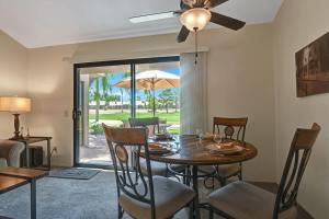 a dining room with a table with chairs and a ceiling fan at PN561 - Jupiter View - Alice Lodging in Palm Desert