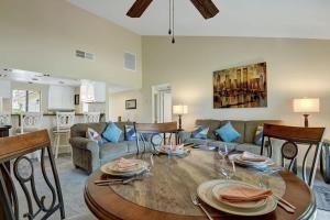 a living room with a table and a couch at PN561 - Jupiter View - Alice Lodging in Palm Desert