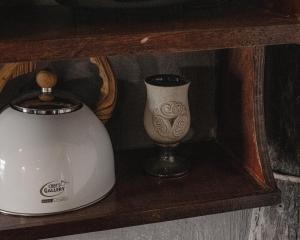 a shelf with a tea pot and a vase on it at Hayag in General Luna +16 photos