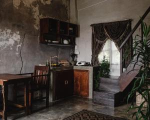 a kitchen with a sink and a table and a window at Hayag in General Luna