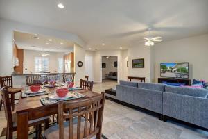 a living room with a table and a couch at Sun City Fun - Alice Lodging in Indio