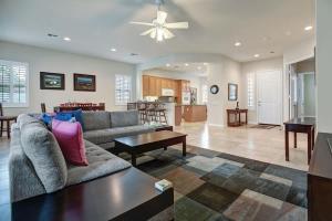 a living room with a couch and a table at Sun City Fun - Alice Lodging in Indio
