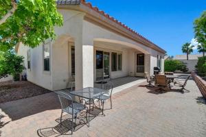 a patio with chairs and a table in front of a house at Sun City Fun - Alice Lodging in Indio +31 photos