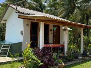 a small house with a table in front of it at Ship Villa in Habarana