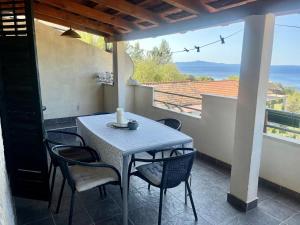 a table and chairs on a balcony with a view of the ocean at Apartments with parking space Ivan Dolac, Hvar - 8753 in Ivan Dolac