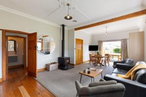 a living room with a couch and a stove at Makoura Lodge in Apiti