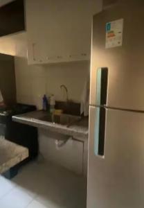 a kitchen with a refrigerator and a sink at Ap charmoso in Mossoró