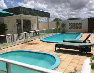 two large swimming pools on top of a building at Ap charmoso in Mossoró