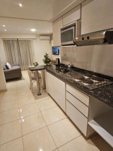 a kitchen with a stove and a counter top at Nidale Suites 2 in La Rioja +10 photos