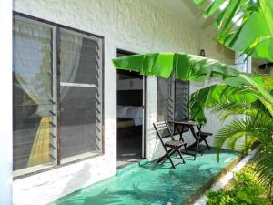 a patio with two chairs and a table on a balcony at Simon's Place in Nuku‘alofa