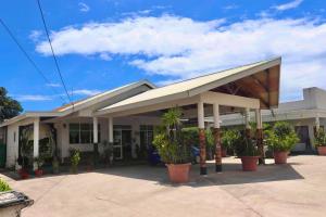 a building with potted plants in front of it at Simon's Place in Nuku‘alofa