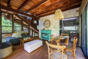 a living room with a couch and a table at Vida Silvestre Tulum in Tulum