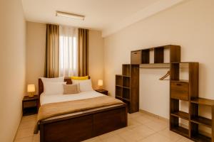 a bedroom with a bed and a book shelf at Appartements Des Roses in Le Lamentin +41 photos