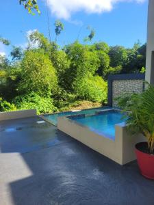 a swimming pool in the middle of a yard at Mountain View Vacation Home in Petite Soufrière