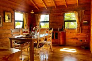 a dining room with a table and chairs at The Coal Miners Hut in Waimangaroa
