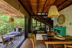 an outdoor living room with a table and chairs at Vida Silvestre Tulum in Tulum