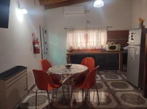 a kitchen with a table with chairs and a refrigerator at Las Tres Reinas B in Colorado River