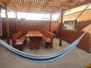 a hammock room with a wooden table and benches at Las Tres Reinas B in Colorado River
