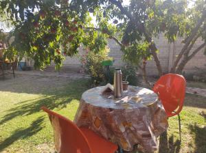 a table with two chairs and a bottle on it at Las Tres Reinas B in Colorado River +3 photos