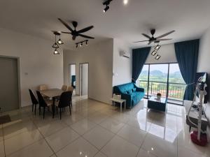 a living room with a table and a blue couch at Horizon Rooftop Skypool Condotel - Ipoh in Ipoh