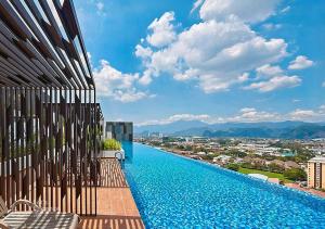 a swimming pool on the side of a building at Horizon Rooftop Skypool Condotel - Ipoh in Ipoh