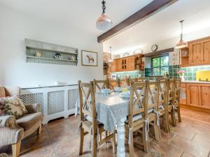 a kitchen and dining room with a table and chairs at Berwyn Bank in Gilcrux