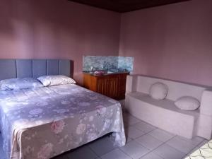 a bedroom with a bed and a desk and a table at kit net Rua Ildo Meneghetti, 160 in Alegrete