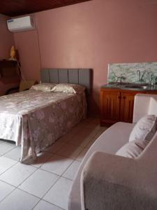 a bedroom with a bed and a sink at kit net Rua Ildo Meneghetti, 160 in Alegrete