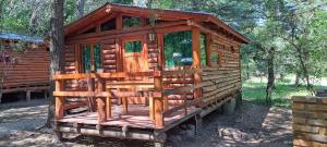 a wooden cabin in the middle of a forest at Cabañas El Oasis del Peñón in Casa Grande