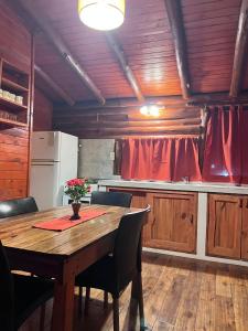 a kitchen with a wooden table in a room at Cabañas El Oasis del Peñón in Casa Grande