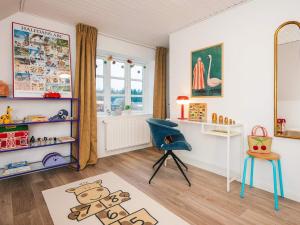 a childs room with a blue chair and a desk at Nature Escape Forest & Lake Access in Viborg