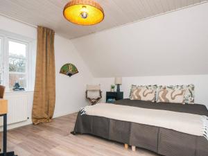a bedroom with a large bed and a window at Nature Escape Forest & Lake Access in Viborg