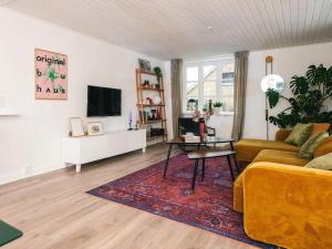 a living room with a couch and a table at Nature Escape Forest & Lake Access in Viborg