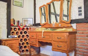 a bathroom with a wooden dresser with a mirror at Beautiful Apartment In Reifferscheid in Reifferscheid +9 photos