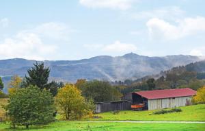 a barn in a field with mountains in the background at Beautiful Apartment In Reifferscheid in Reifferscheid