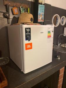 a white refrigerator sitting on a counter in a kitchen at Tayka Suite in La Serena