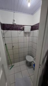 a small bathroom with a toilet in a room at Pousada Moschen in Passo de Torres