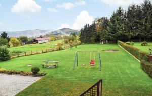 a park with a playground with a swing at Beautiful Apartment In Reifferscheid in Reifferscheid