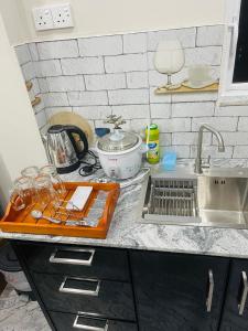 a kitchen counter with a cutting board and a sink at Horizon in Katunayaka +13 photos