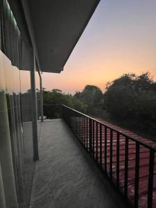 a balcony of a house with a sunset in the background at Horizon in Katunayaka