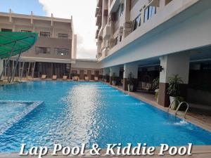a large swimming pool in the middle of a building at Carol sweet room in Cebu City