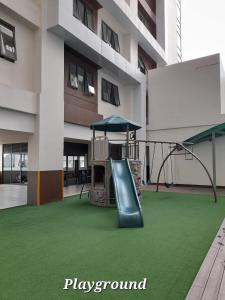a playground in front of a building with a slide at Carol sweet room in Cebu City