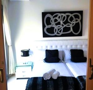 a bedroom with a bed and a picture on the wall at Attic Center Sitges in Sitges