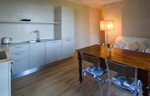 a kitchen with a wooden table and chairs and a sink at Case Sparse San Savino in San Savino +10 photos