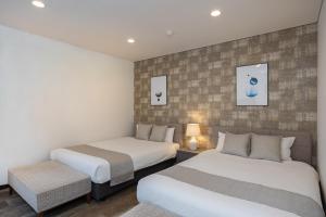 two beds in a hotel room with two beds at Bijou Suites AI PREMIUM in Osaka +41 photos