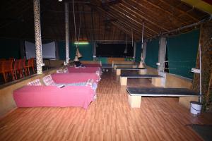 a room with couches and ping pong tables at Hampi Blue Moon Resort in Munirābād +19 photos
