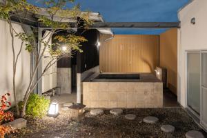 an external view of a house with a courtyard at Bijou Suites AI PREMIUM in Osaka